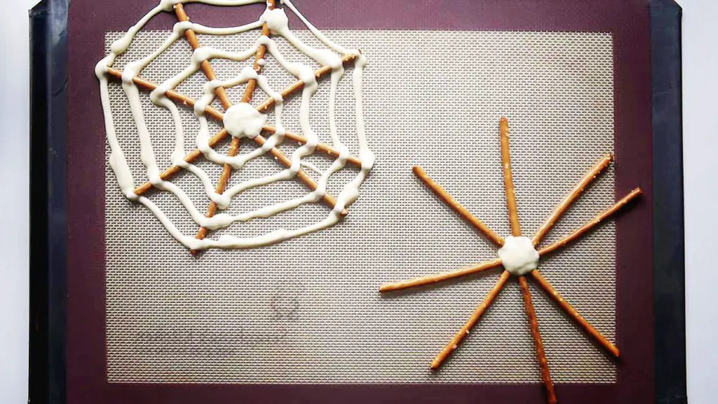making halloween pretzel spider webs