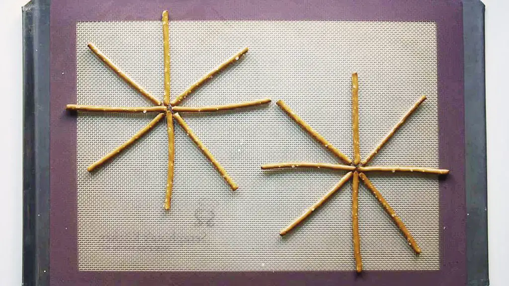pretzel sticks arranged in a radial formation on a silicone mat