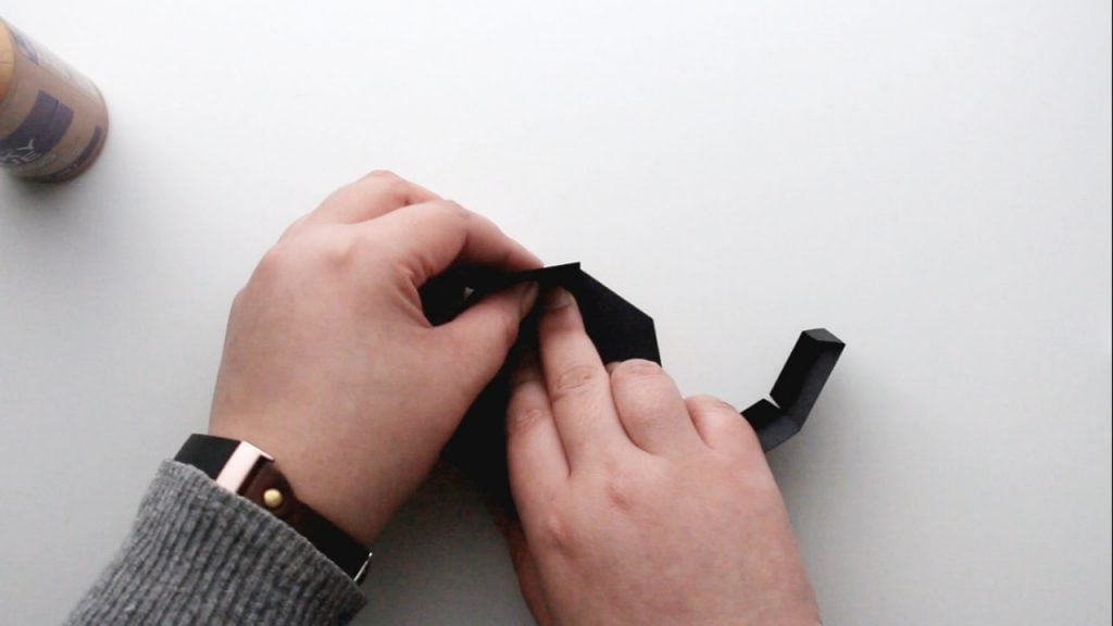 press down to stick the tabs to the base of the treat box