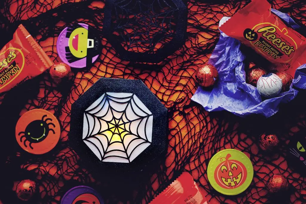top view of the closed spider web treat box being ussed as a lantern with an led tea light inside